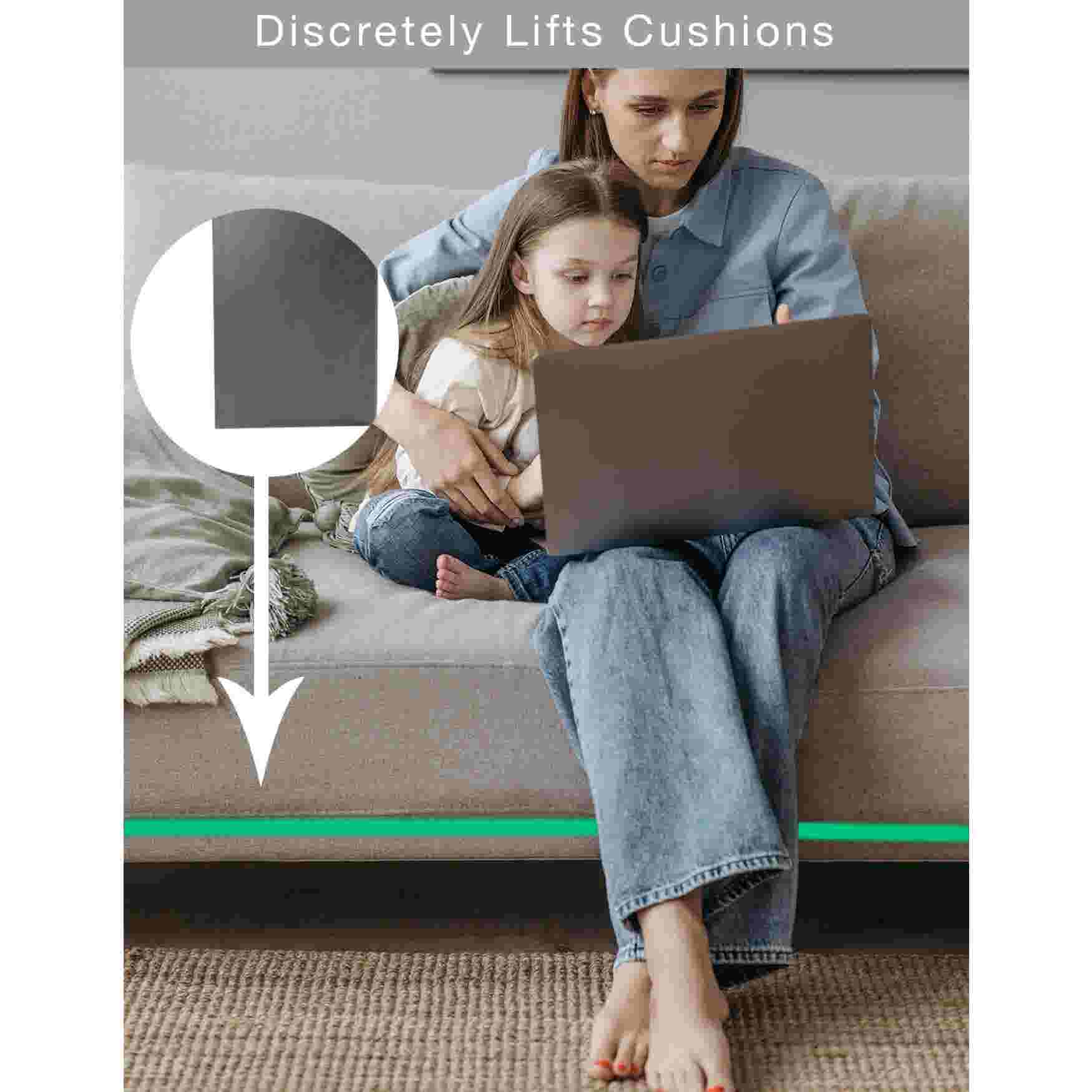 A woman and a child sitting on a couch with a sofa cushion support underneath.